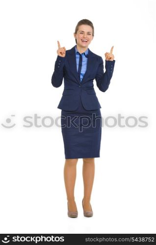 Full length portrait of happy business woman pointing up on copy space