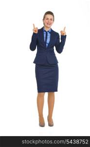 Full length portrait of happy business woman pointing up on copy space