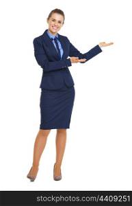 Full length portrait of happy business woman showing something