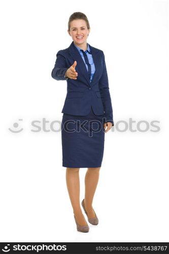 Full length portrait of happy business woman stretching hand for handshake