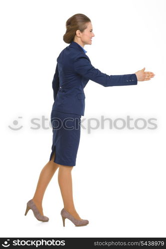 Full length portrait of happy business woman stretching hand for handshake