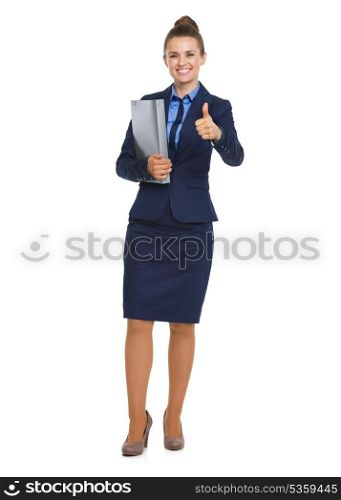 Full length portrait of happy business woman with folder showing thumbs up