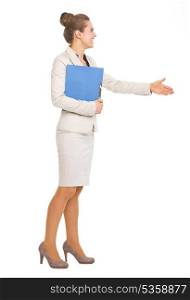 Full length portrait of happy business woman with folder stretching hand for handshake