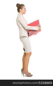Full length portrait of happy business woman with stack of folders