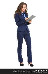 Full length portrait of happy business woman working with tablet pc
