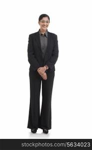 Full length portrait of happy businesswoman standing against white background