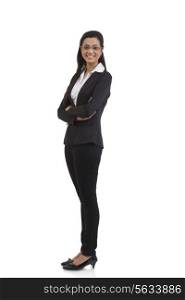 Full length portrait of happy businesswoman with arms crossed standing against white background