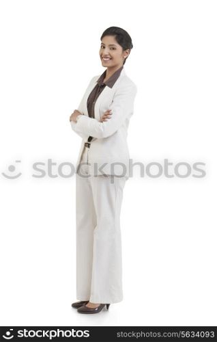 Full length portrait of happy confident businesswoman with arms crossed isolated over white background