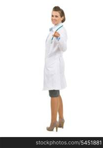 Full length portrait of happy doctor woman pointing in camera