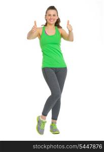 Full length portrait of happy fitness young woman showing thumbs up