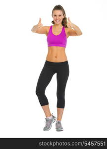 Full length portrait of happy fitness young woman showing thumbs up