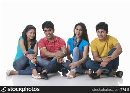Full length portrait of happy friends siting over white background