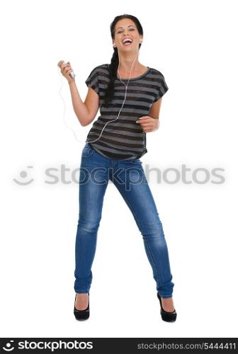 Full length portrait of happy girl with headphones dancing