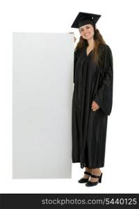 Full length portrait of happy graduation student holding blank billboard