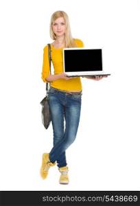 Full length portrait of happy student girl showing laptop