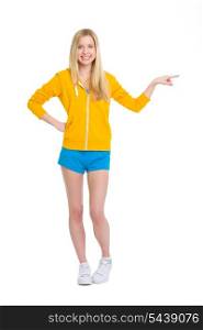 Full length portrait of happy teenager girl pointing on copy space