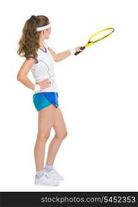 Full length portrait of happy tennis player pointing with racket on copy space