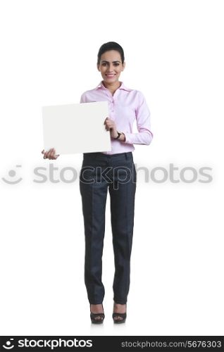 Full length portrait of happy young businesswoman showing blank board over white background