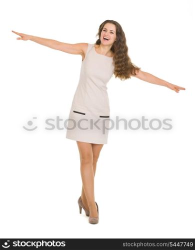 Full length portrait of happy young woman balancing