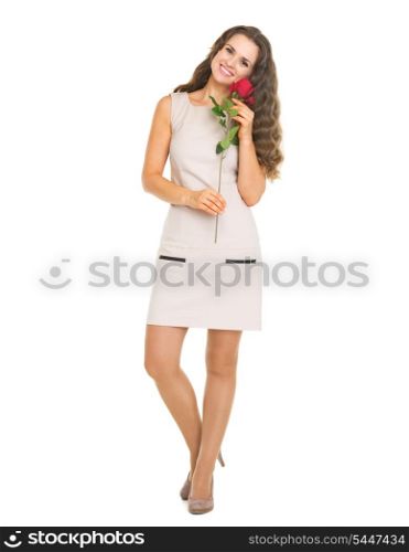 Full length portrait of happy young woman holding red rose