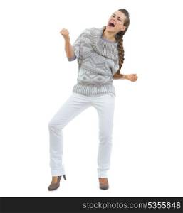 Full length portrait of happy young woman in sweater dancing