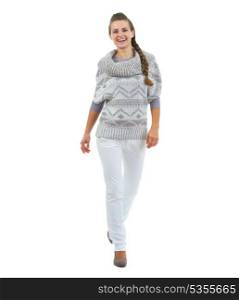 Full length portrait of happy young woman in sweater going straight