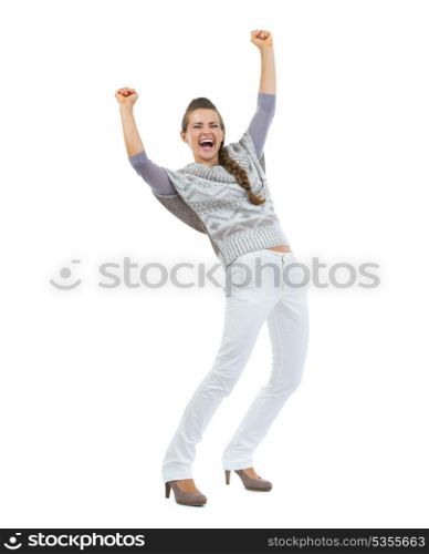 Full length portrait of happy young woman in sweater rejoicing success