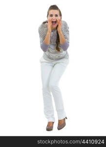 Full length portrait of happy young woman in sweater shouting through megaphone shaped hands