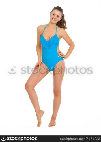 Full length portrait of happy young woman in swimsuit