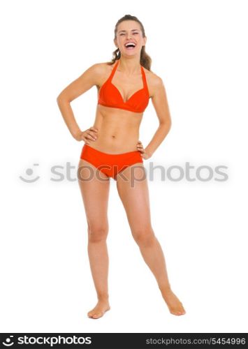 Full length portrait of happy young woman in swimsuit