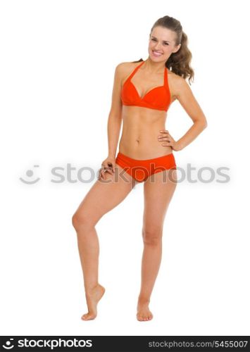 Full length portrait of happy young woman in swimsuit