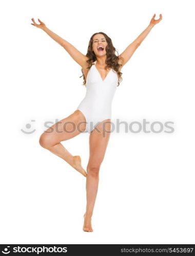 Full length portrait of happy young woman in swimsuit rejoicing