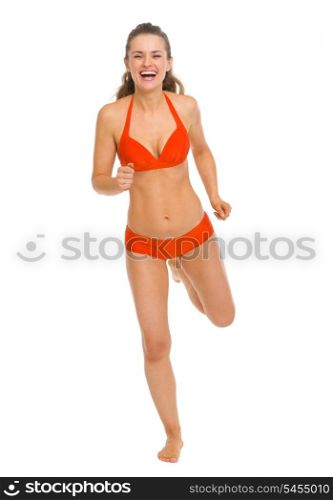 Full length portrait of happy young woman in swimsuit running