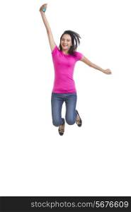 Full length portrait of happy young woman jumping over white background