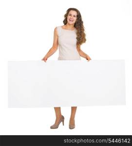 Full length portrait of happy young woman showing blank billboard
