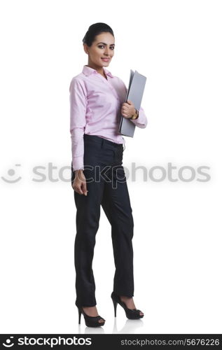 Full length portrait of Indian businesswoman holding file folder over white background