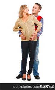 Full length portrait of man hugging tummy of his pregnant wife isolated on white&#xA;
