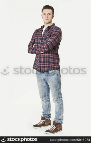 Full Length Portrait Of Man Standing In Studio On White Background