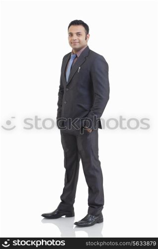 Full length portrait of mid adult businessman with hand in pocket isolated over white background