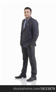 Full length portrait of mid adult businessman with hand in pocket isolated over white background