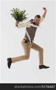 Full length portrait of modern groom dancing and jumping with wedding bouquet