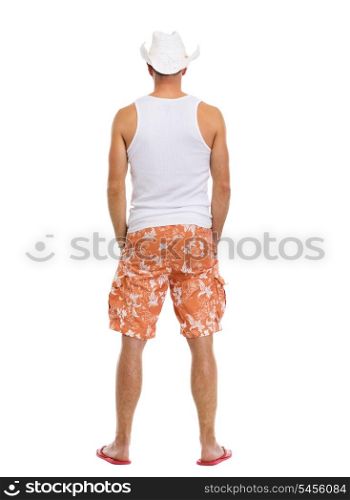 Full length portrait of on vacation man in shorts. Rear view