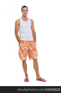 Full length portrait of on vacation smiling young man in shorts