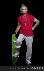 Full length portrait of senior man with skateboard