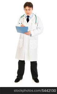 Full length portrait of serious making notes in medical chart isolated on white&#xA;
