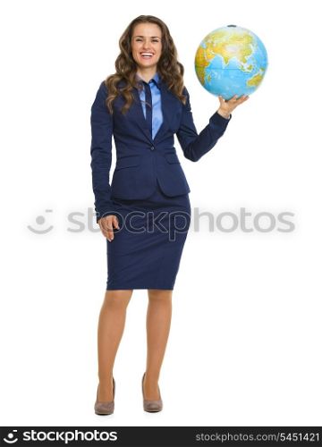 Full length portrait of smiling business woman holding earth globe
