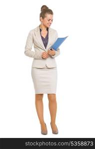 Full length portrait of smiling business woman looking on folder in hands