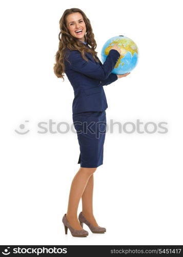 Full length portrait of smiling business woman pointing in earth globe