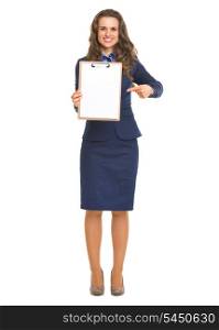 Full length portrait of smiling business woman pointing on blank clipboard