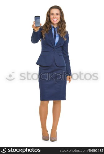 Full length portrait of smiling business woman showing cell phone